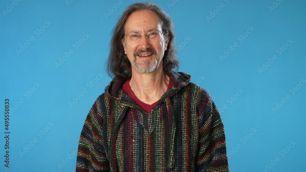 Smiling bearded mature man 50s 60s years old wearing t-shirt isolated on solid blue background studio. People sincere emotions lifestyle concept. Looking camera Smiling bearded mature man 50s 60s years old wearing t-shirt isolated on solid blue background studio. People sincere emotions lifestyle concept. Looking camera