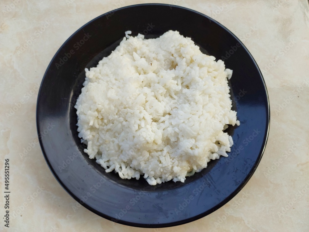 White rice on the black plate White rice on the black plate