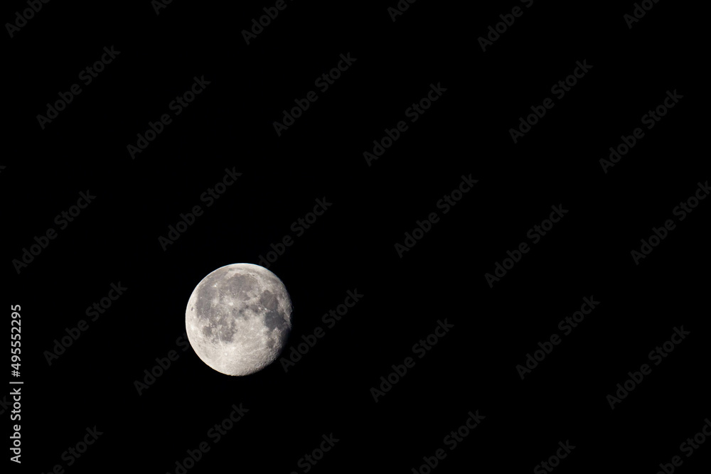 Moon on March 20, 2022 in the waning gibbous phase with 94% illumination by the sun with copy space Moon on March 20, 2022 in the waning gibbous phase with 94% illumination by the sun with copy space