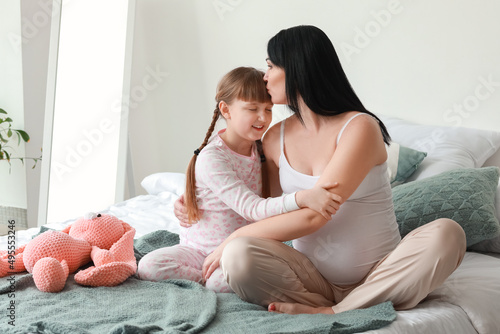 Little girl with her pregna...