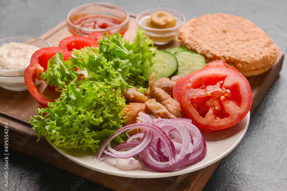 Plate with ingredients for fresh doner kebab on dark background Plate with ingredients for fresh doner kebab on dark background