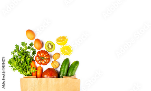 Healthy food background. Healthy vegan vegetarian food in paper bag vegetables on white  copy space. Shopping food supermarket and clean vegan eating concept.