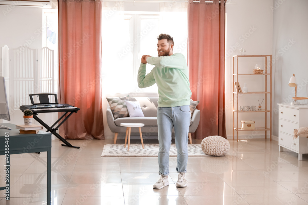 Cool young man learning to dance at home Cool young man learning to dance at home