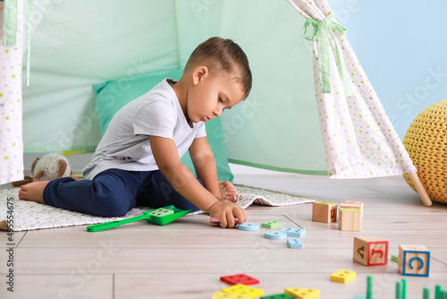Cute little boy playing wit...