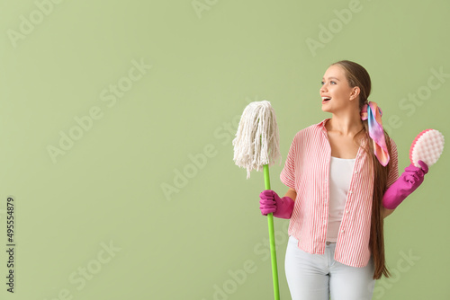 Young woman with sponge and...