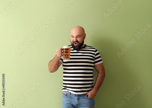 Happy bald man with beer on...