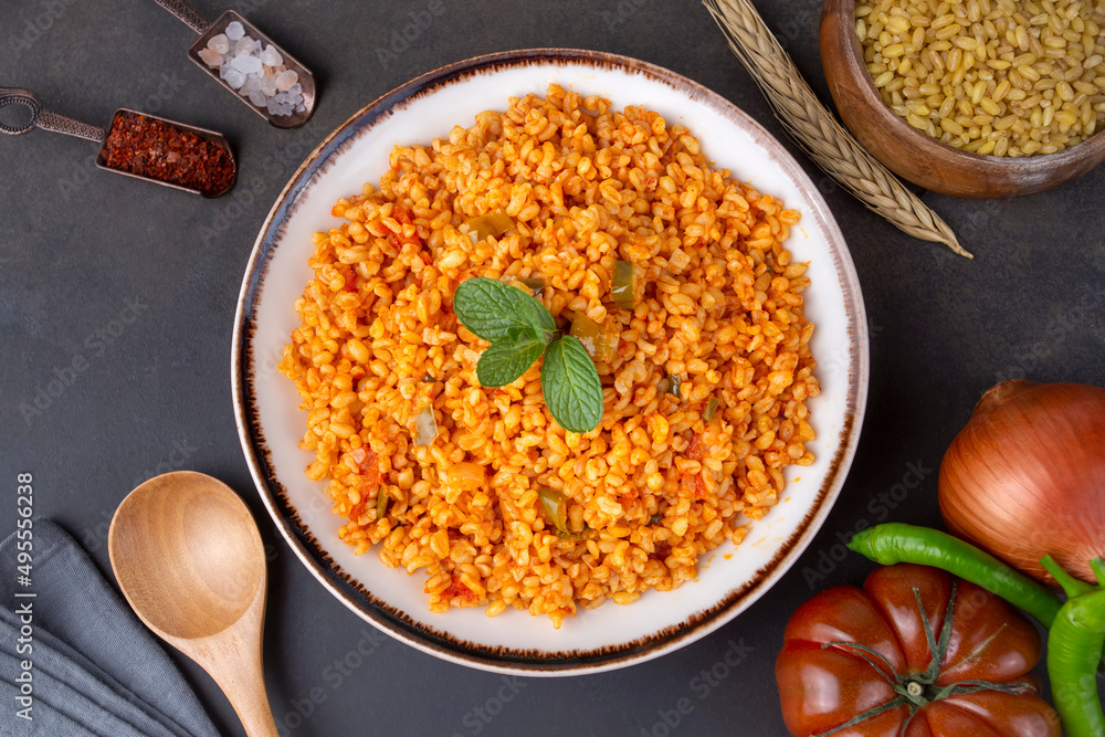 Traditional turkish bulgur pilaf with tomato sause in plate (Turkish name; meyhane pilavi) Traditional turkish bulgur pilaf with tomato sause in plate (Turkish name; meyhane pilavi)