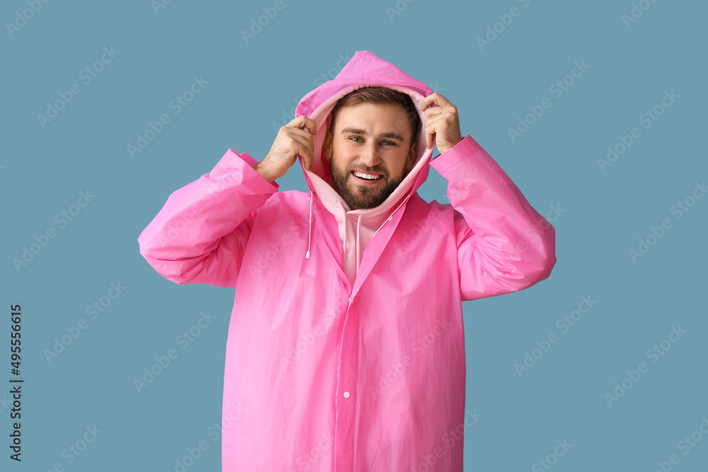 Young man in stylish raincoat on color background Young man in stylish raincoat on color background