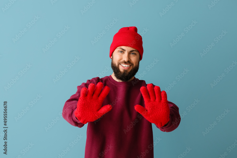 Handsome man in winter clothes on color background Handsome man in winter clothes on color background