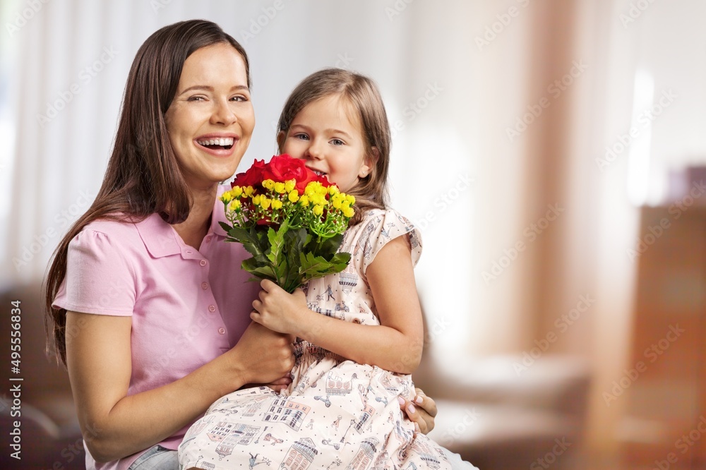 Happy woman child with tulips smiling with eyes. celebrating holiday at home Happy woman child with tulips smiling with eyes. celebrating holiday at home