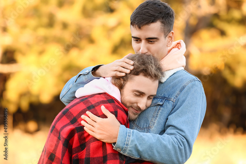 Happy gay couple hugging in autumn park © Pixel-Shot