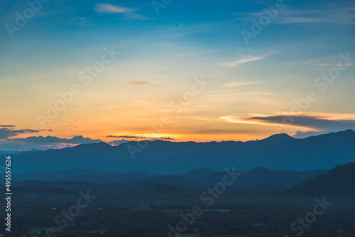 Blue golden sky sunrise dramatic beautiful landscape mountain. Dawn sky gold dusk time cloudscape with sunlight. Dramatic sunset over mountain landscape. Beautiful landscape foggy hills twilight time