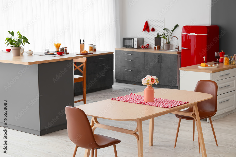 Interior of modern kitchen with red fridge, counters and pegboard Interior of modern kitchen with red fridge, counters and pegboard