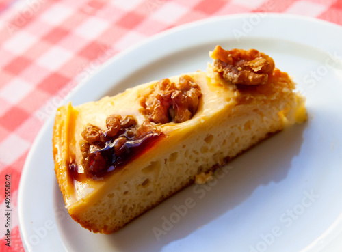 Tasty dessert, slice of fluffy cake decorated with nuts