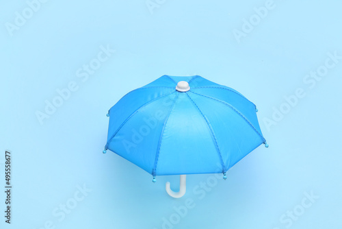 Open umbrella on blue background