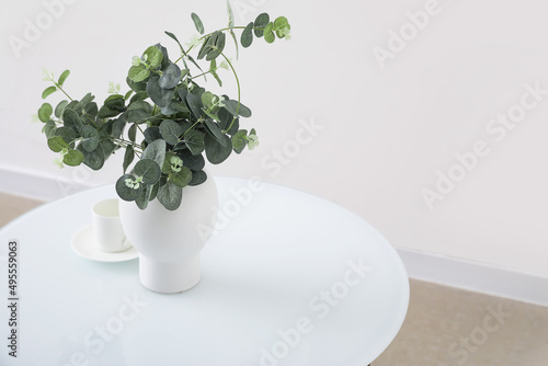 Modern table with houseplant in interior of light room, closeup