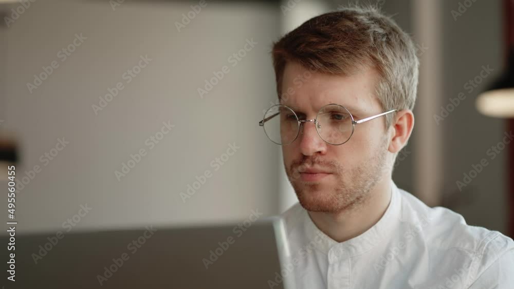 office worker is looking at screen of laptop and thinking, reading information and sending email office worker is looking at screen of laptop and thinking, reading information and sending email