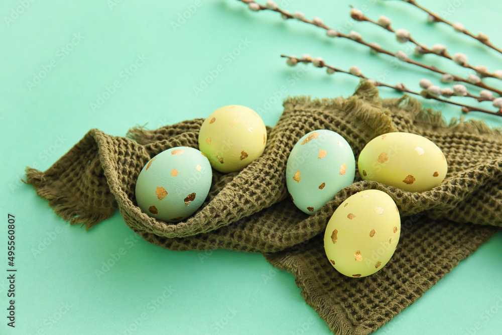 Obraz premium Painted Easter eggs and willow branches on blue background