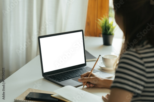 Wallpaper Mural Young woman work on laptop with blank display screen with mockup copy space. Modern home living room interior design. Work at home concept. Torontodigital.ca
