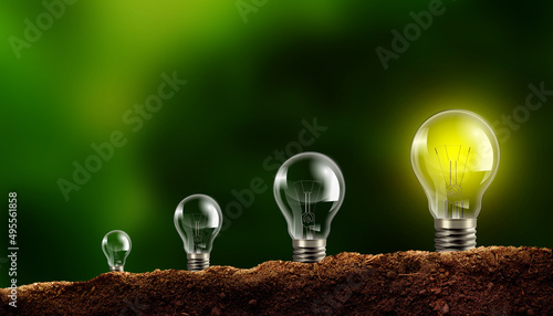 Growing Light bulb on Soil. Developed Lamp Grow up, Turn on and Stand Out.  Growth, Sustainable Environment, Ecological Friendly and Saving Energy 