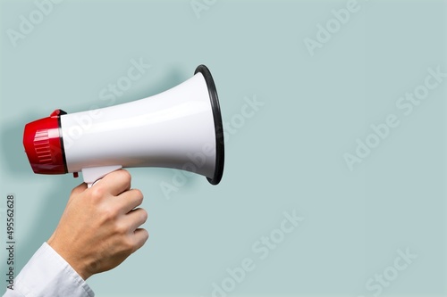 Attention. hand holds loudspeaker which is symbol of advertising,  announcement, warning and advertising concept. photo