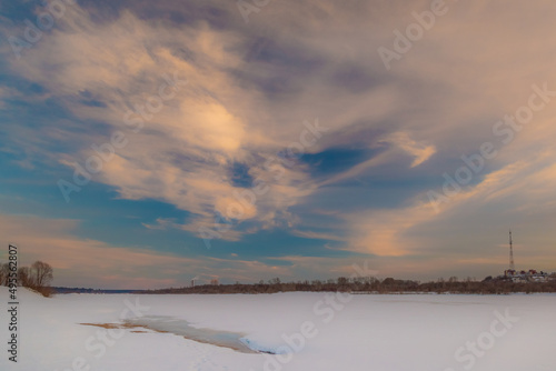 the setting sun beautifully illuminates the clouds over the city on a frosty winter evening