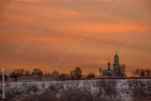 the setting sun beautifully illuminates the clouds over the city on a frosty winter evening