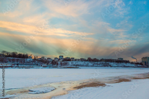the setting sun beautifully illuminates the clouds over the city on a frosty winter evening