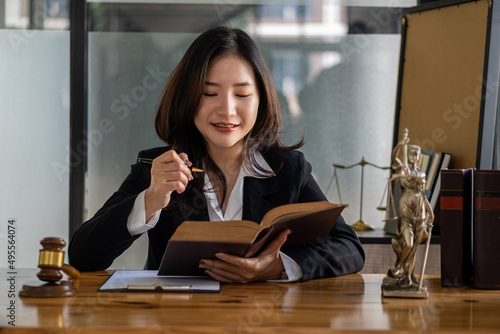 Lawyer's Office. The goddess of justice with scales and lawyers working on law, advice, and justice. Female lawyer at work with hammer and femida in office