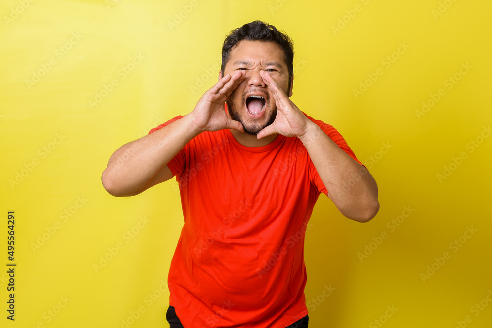 Closeup portrait of upset, angry fat man with hands close to wide opened mouth yelling, isolated on yellow background. Negative emotion, feelings. Closeup portrait of upset, angry fat man with hands close to wide opened mouth yelling, isolated on yellow background. Negative emotion, feelings.