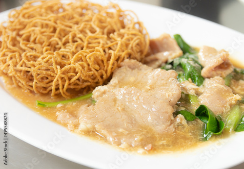 Crispy noodle with pork in thick gravy sauce. Chinese food