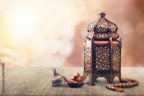 Ramadan Kareem and iftar Muslim holiday concept. Dried dates and lanterns with candles. photo