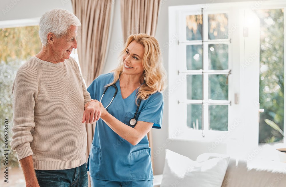 Taking it one step at a time. Shot of a female nurse helping her elderly male patient. Taking it one step at a time. Shot of a female nurse helping her elderly male patient.
