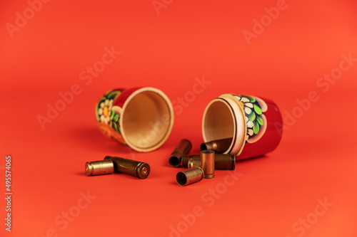 Wallpaper Mural Matryoshka and sleeves against a kora background. Tradition Russian symbol and empty pistol and submachine gun casings. The concept of military aggression Torontodigital.ca