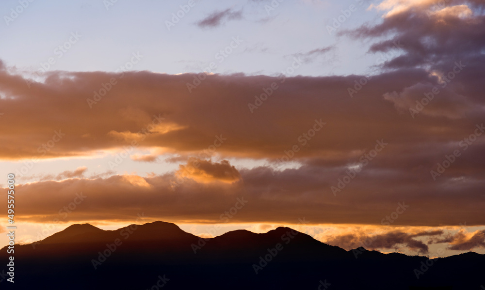 Beautiful sunset sky with clouds in mountains
