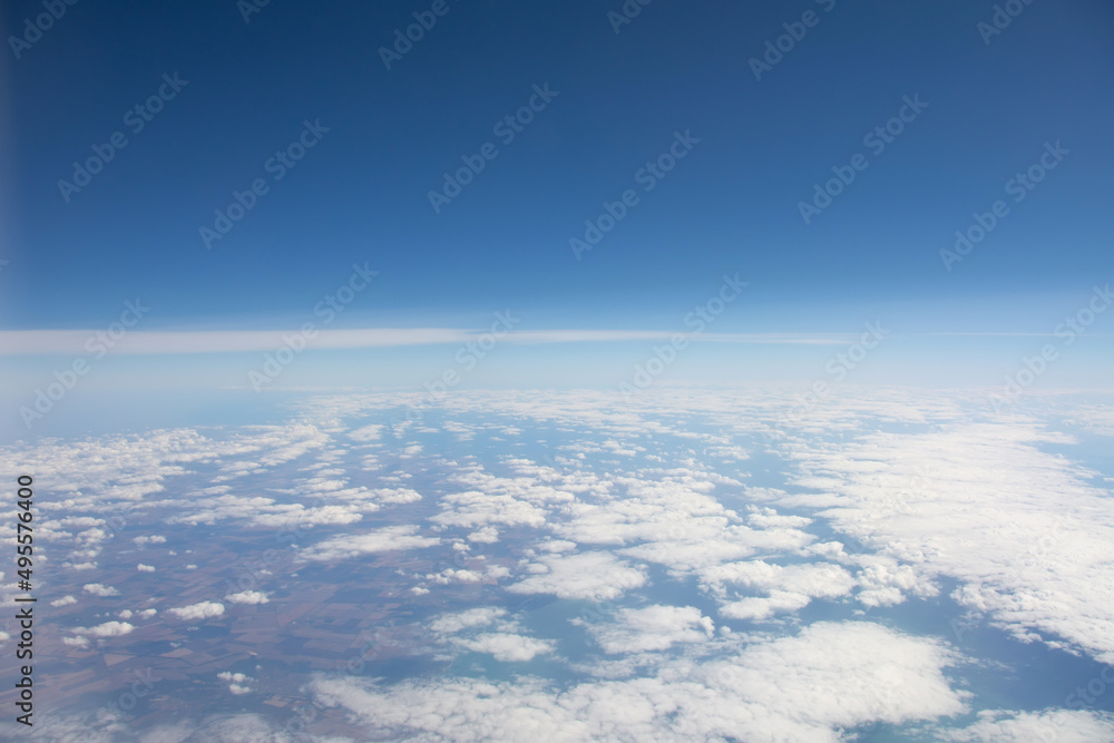 Cloudiness over the earth's surface from a height during an airplane flight.