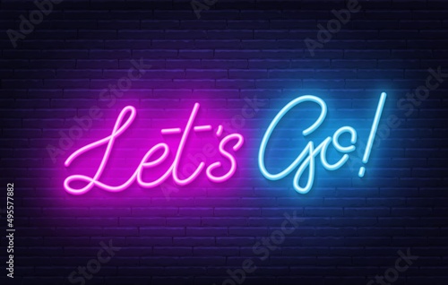Let's go neon quote on a brick wall.