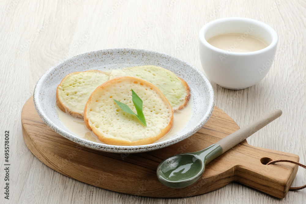 Serabi or Surabi, Indonesian pancake made of flour, rice flour and coconut milk. Served with palm sugar sauce. Sweet and savory.
Serabi or Surabi, Indonesian pancake made of flour, rice flour and coconut milk. Served with palm sugar sauce. Sweet and savory.