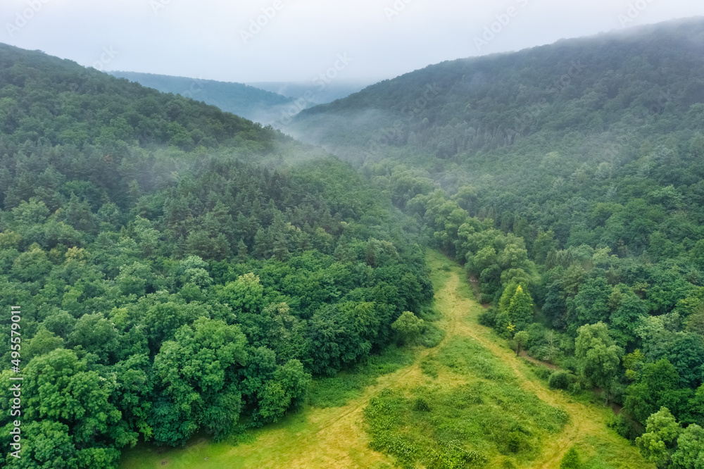 Aerial view drone shot of mountain tropical rainforest,Bird eye view image over the clouds Amazing nature background with clouds and mountain peaks