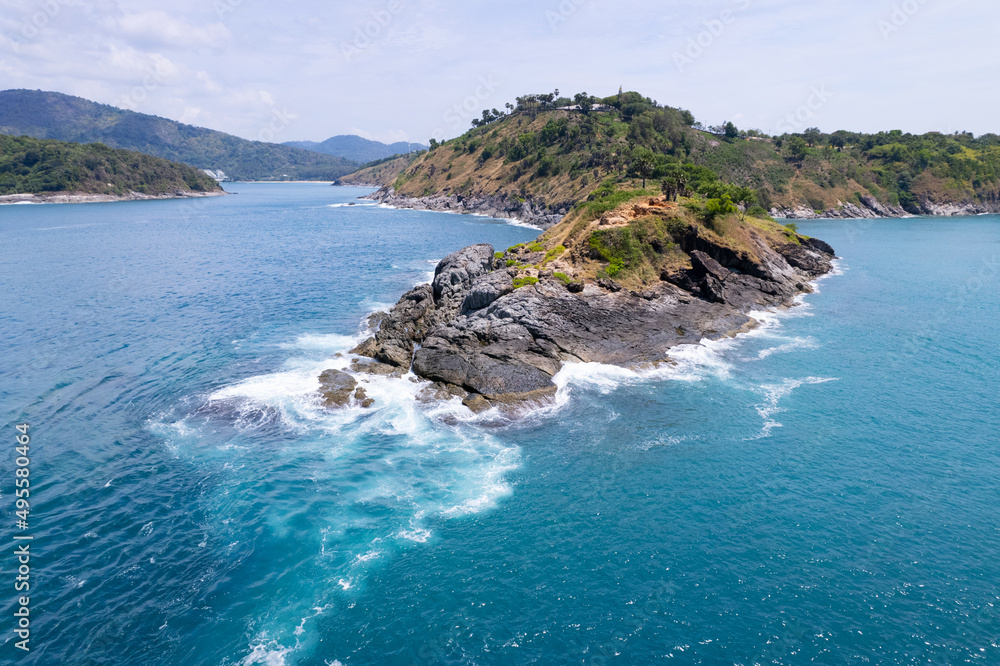 Aerial view phuket seashore Wave crashing on rocks at Laem promthep cape beautiful sea in Phuket Thailand.Phuket view point is famous tourist destination at Thailand Aerial view phuket seashore Wave crashing on rocks at Laem promthep cape beautiful sea in Phuket Thailand.Phuket view point is famous tourist destination at Thailand