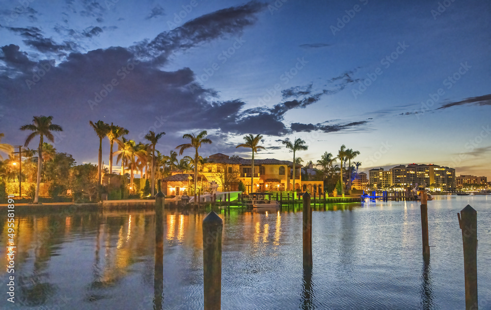 Buildings of Boca Raton at night along the water, Florida.