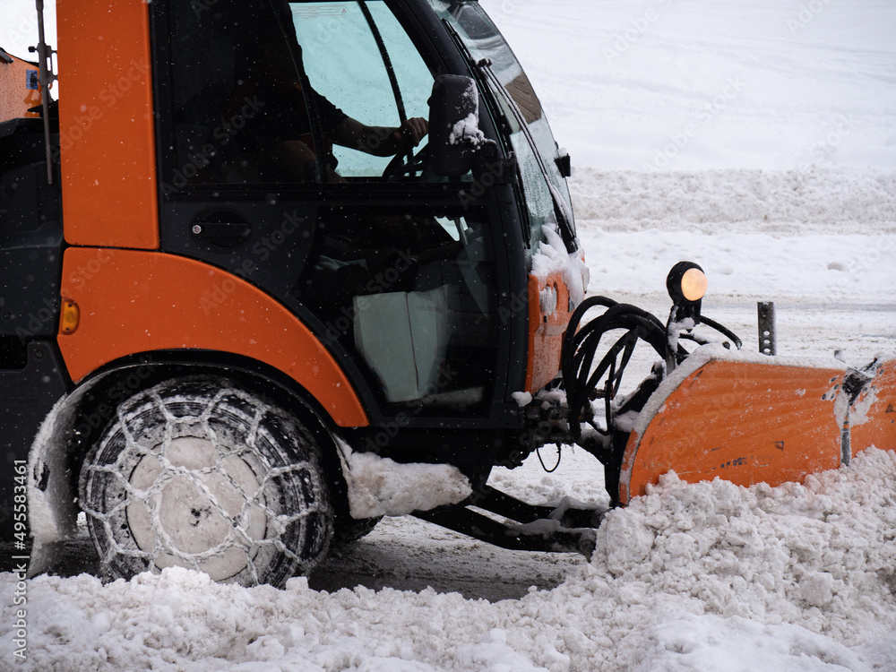 Road Vehicle Snowplow in action on Whitewashed Roads During a Snowy Day Road Vehicle Snowplow in action on Whitewashed Roads During a Snowy Day