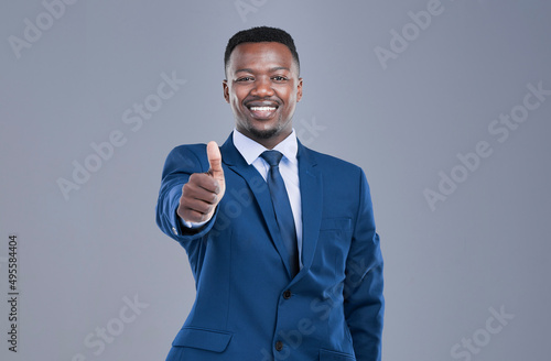 Youve got my approval. Cropped portrait of a handsome young businessman giving you a thumbs up in studio against a grey background.
