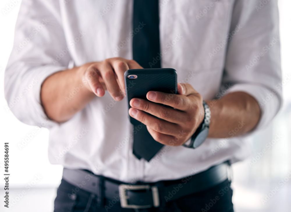The tools of my success. Shot of a businessman using his smartphone to send a text message. The tools of my success. Shot of a businessman using his smartphone to send a text message.