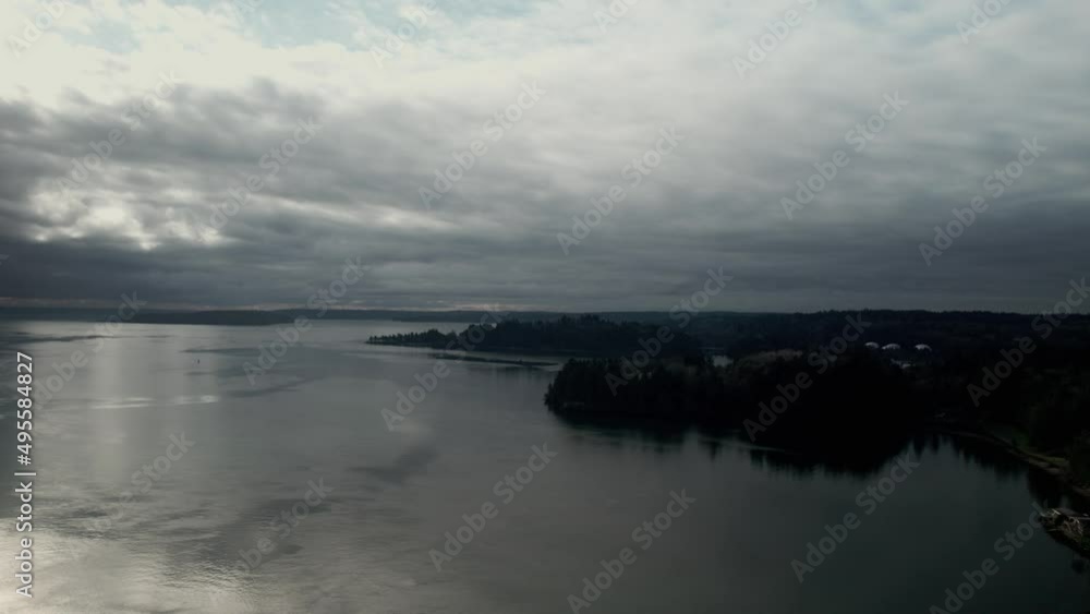 Gloomy dark skies reflect off the calm waters of Puget Sound, Washington, aerial Gloomy dark skies reflect off the calm waters of Puget Sound, Washington, aerial