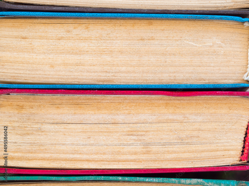 Books in the stack -background. Books and reading are necessary for self-improvement, gaining knowledge and success in career, business and personal life. Texture of various books stacked Books in the stack -background. Books and reading are necessary for self-improvement, gaining knowledge and success in career, business and personal life. Texture of various books stacked