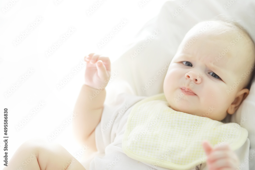 Maternity concept. A young mother feeds her little baby. First lure and breastfeeding. Family in white clothes. Maternity concept. A young mother feeds her little baby. First lure and breastfeeding. Family in white clothes.