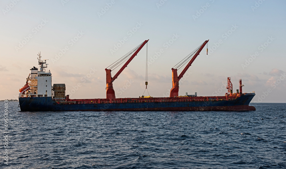 Large cargo ship at anchor on open sea