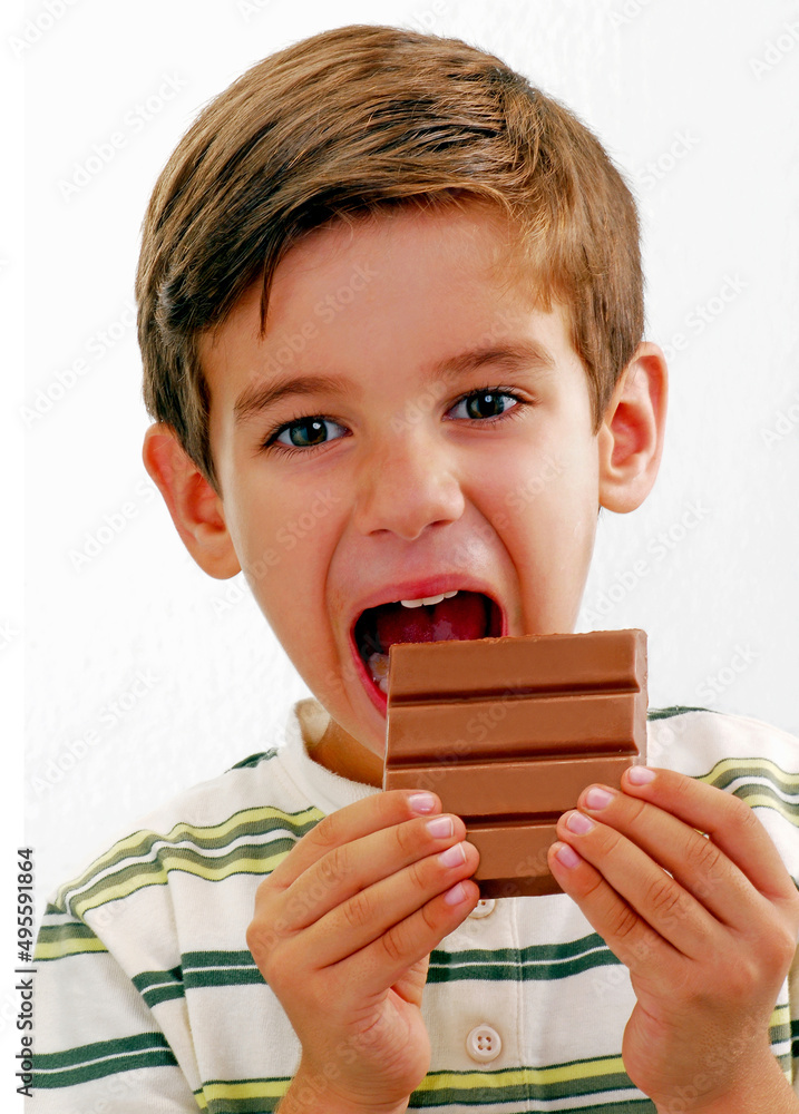 Kid eating milky chocolate bar portrait on white background. Kid eating milky chocolate bar portrait on white background.