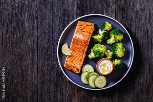 roast salmon fillet with boiled broccoli and sauce photo